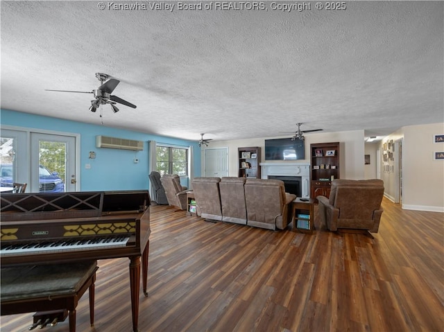 living room with a textured ceiling, dark wood-type flooring, french doors, and a wall mounted air conditioner