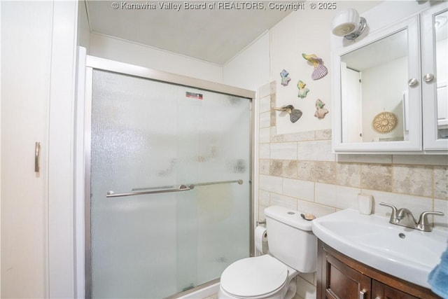 bathroom featuring vanity, decorative backsplash, tile walls, toilet, and walk in shower