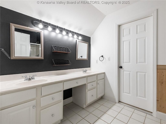 bathroom featuring vaulted ceiling, tile patterned flooring, and vanity