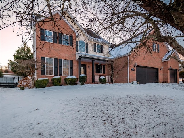 front of property featuring covered porch and a garage