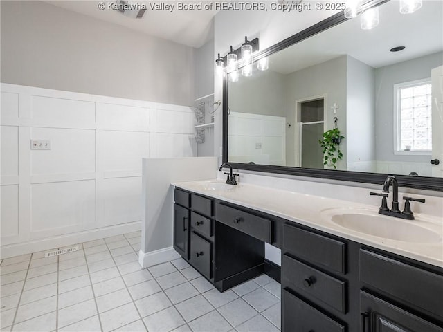 bathroom with tile patterned floors, an enclosed shower, and vanity