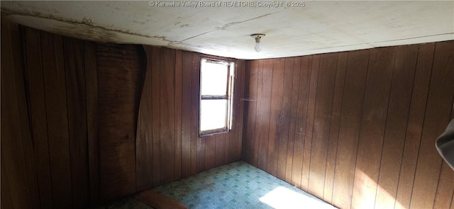 empty room featuring wooden walls