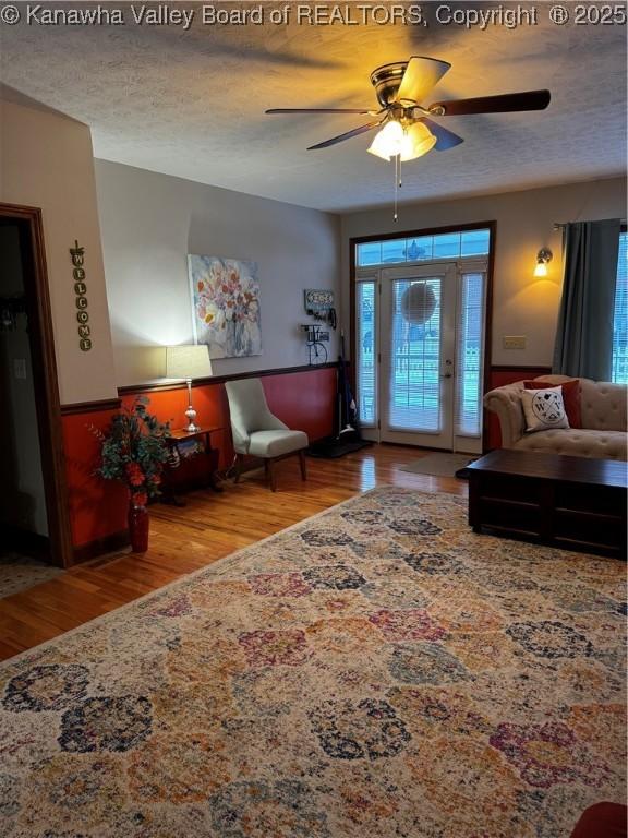 interior space featuring a textured ceiling, ceiling fan, and light hardwood / wood-style floors