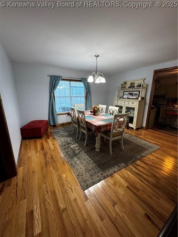 dining space featuring a chandelier and hardwood / wood-style floors