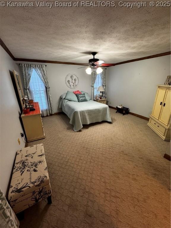 bedroom with ceiling fan, carpet flooring, a textured ceiling, and ornamental molding