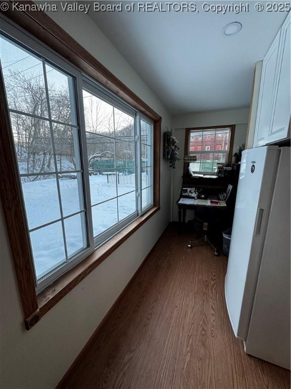 interior space with a healthy amount of sunlight and hardwood / wood-style flooring