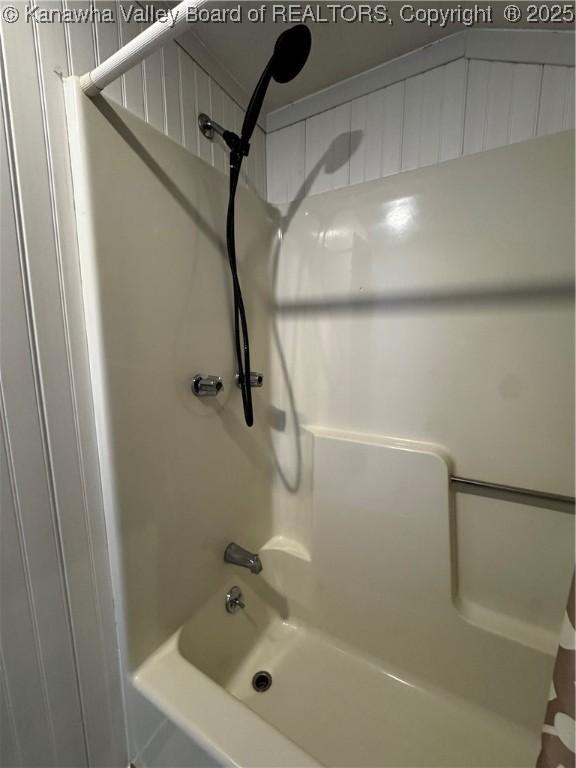 bathroom with shower / bath combo with shower curtain