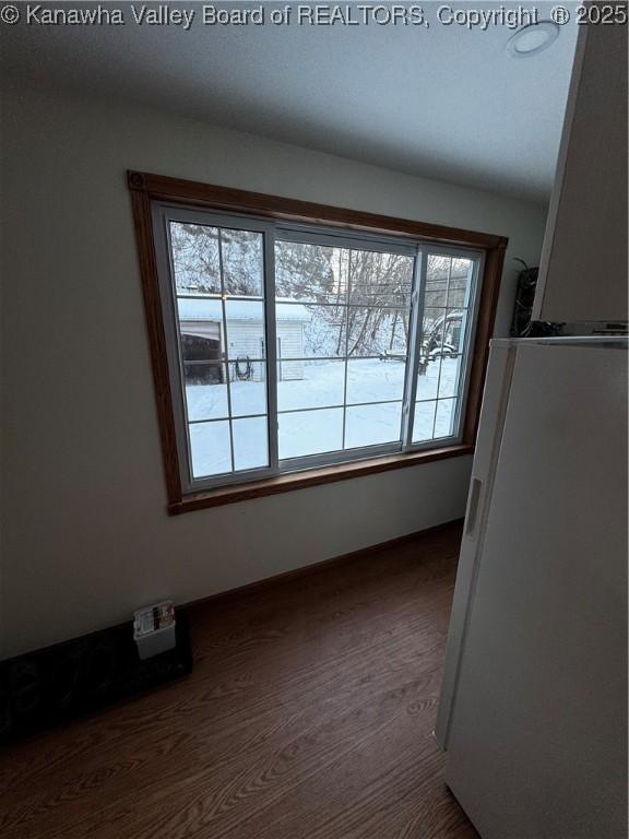 unfurnished dining area featuring dark wood-type flooring