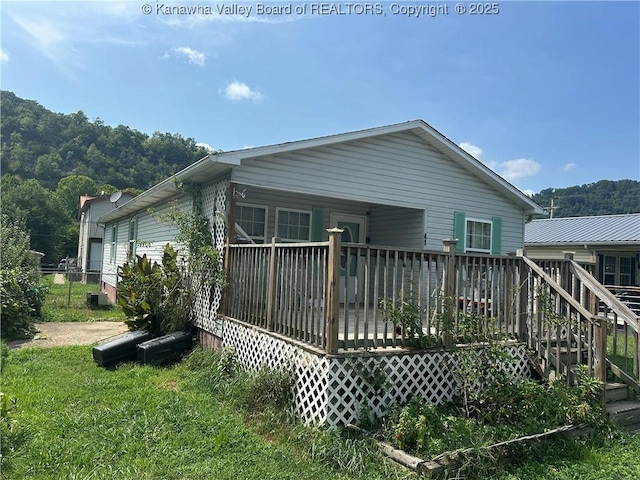 back of house featuring a deck