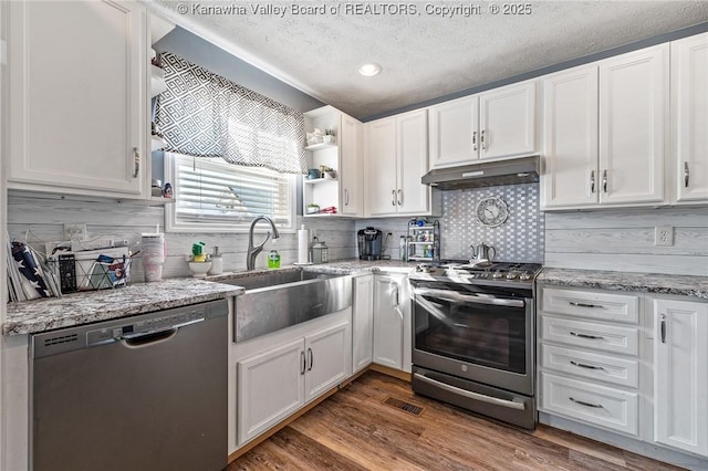 kitchen featuring dishwasher, sink, stainless steel range with gas cooktop, a textured ceiling, and white cabinets