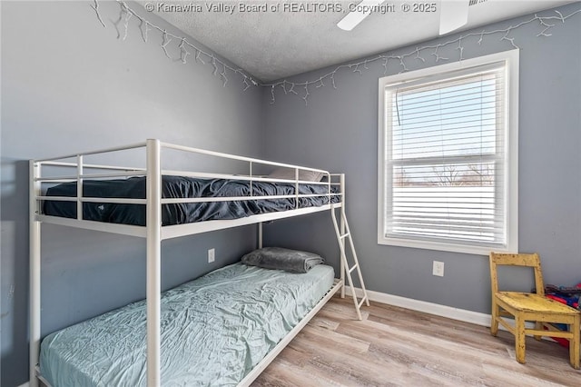 bedroom with ceiling fan and hardwood / wood-style floors