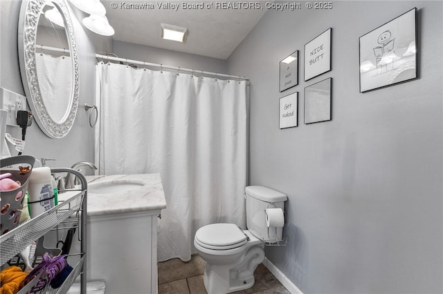 bathroom with toilet, tile patterned floors, vanity, and curtained shower