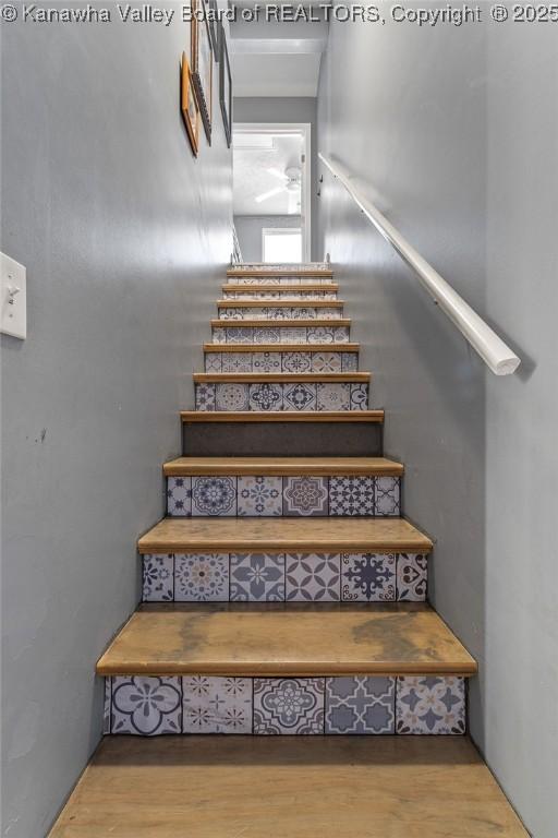 stairway with hardwood / wood-style floors