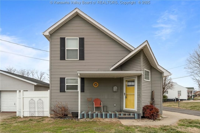 view of front of property featuring a garage and a front lawn