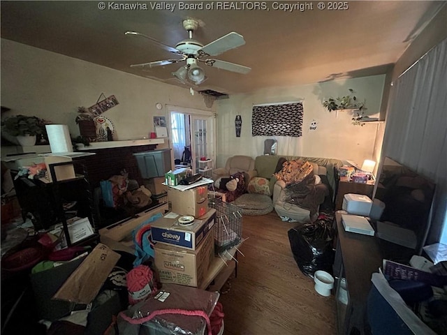 living room with ceiling fan and hardwood / wood-style floors