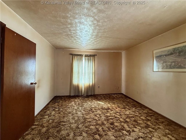 unfurnished room featuring carpet floors and a textured ceiling