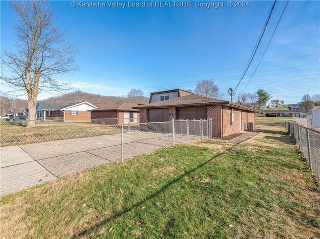 view of front of property featuring a garage and a front lawn