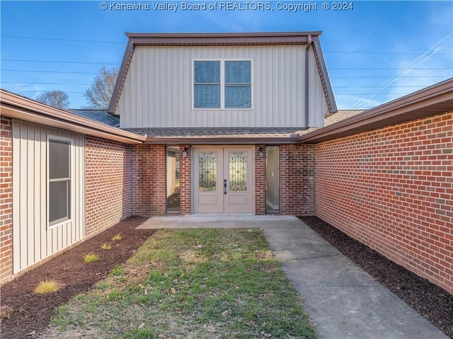 doorway to property with french doors and a yard