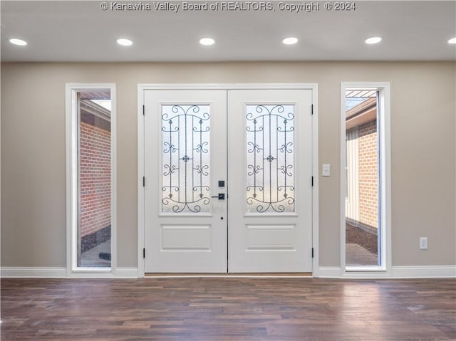 entrance foyer featuring french doors and dark hardwood / wood-style floors