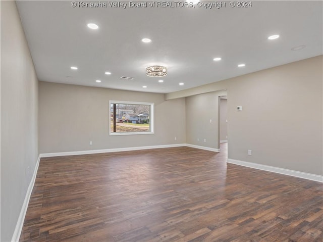 unfurnished room featuring dark wood-type flooring