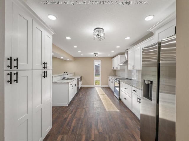 kitchen featuring sink, light stone counters, stainless steel appliances, and white cabinetry