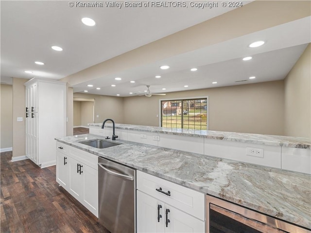 kitchen featuring wine cooler, dishwasher, sink, light stone countertops, and white cabinets