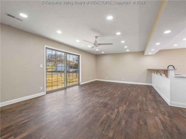 empty room with ceiling fan and dark hardwood / wood-style floors