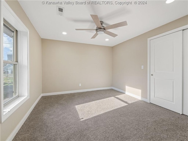 carpeted empty room with ceiling fan