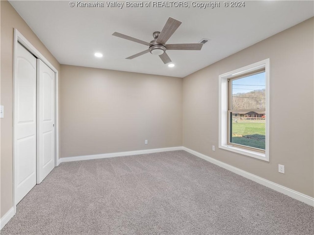 unfurnished bedroom with ceiling fan, a closet, and carpet flooring