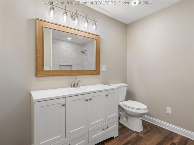 bathroom featuring a shower, wood-type flooring, toilet, and vanity