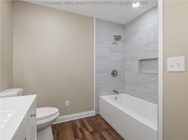 full bathroom featuring toilet, tiled shower / bath, vanity, and hardwood / wood-style flooring