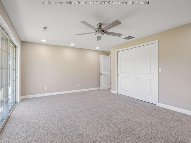 unfurnished bedroom with ceiling fan, carpet, and a closet