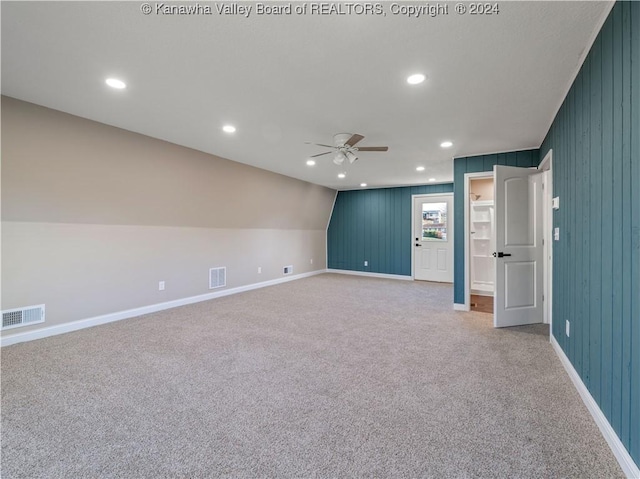 empty room with light carpet, ceiling fan, and lofted ceiling