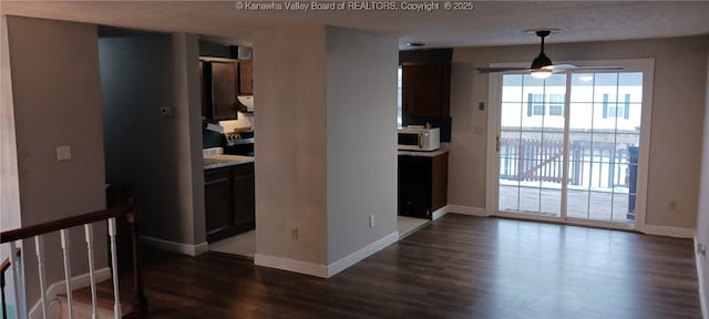 interior space featuring ceiling fan and dark wood-type flooring