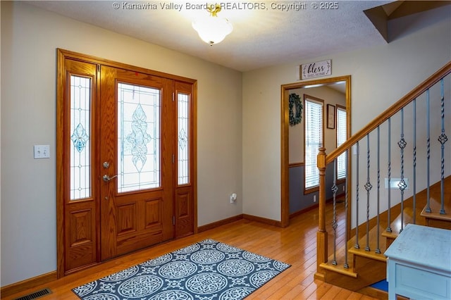 140 Waterside Cir, Winfield, WV 25213 - entrance foyer with light wood-type flooring, stairs, and baseboards