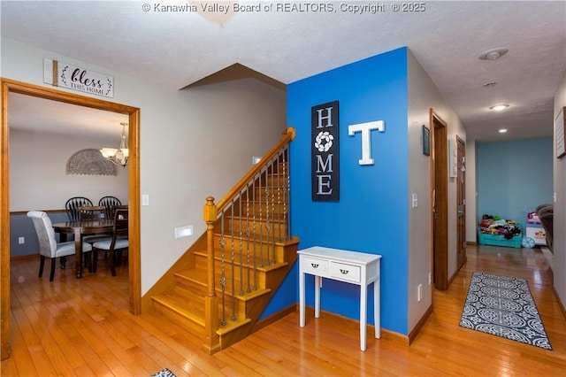 140 Waterside Cir, Winfield, WV 25213 - stairway featuring hardwood / wood-style flooring, baseboards, a chandelier, a textured ceiling, and recessed lighting