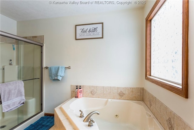 bathroom featuring a textured ceiling and independent shower and bath