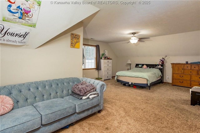 bedroom with ceiling fan, carpet floors, and lofted ceiling