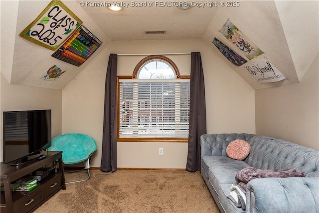 living area with light carpet and vaulted ceiling