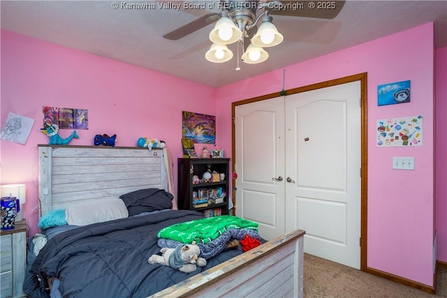 carpeted bedroom with ceiling fan and a closet