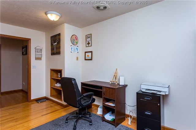 office area featuring a textured ceiling and hardwood / wood-style floors