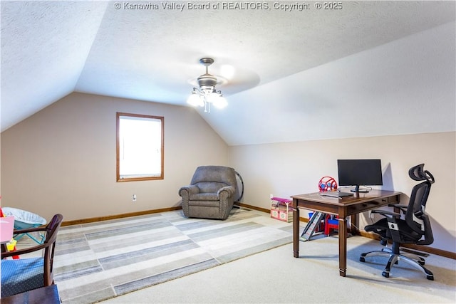 home office featuring ceiling fan, a textured ceiling, carpet flooring, and vaulted ceiling