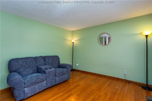 sitting room with hardwood / wood-style flooring