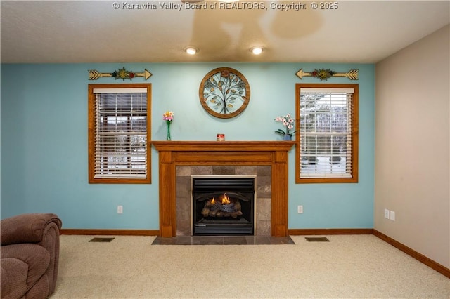 living room with carpet and a tiled fireplace