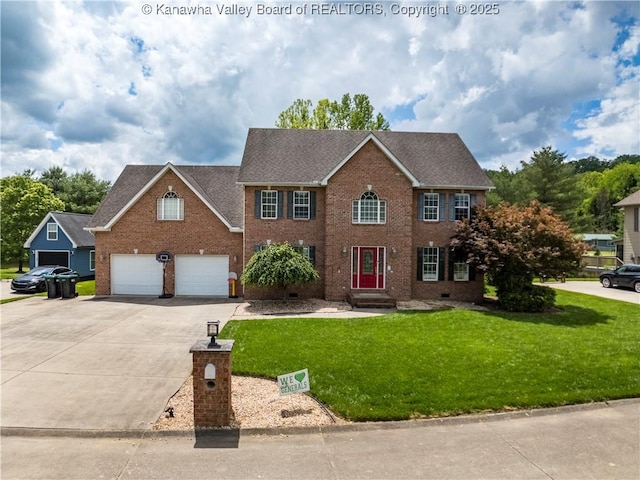 140 Waterside Cir, Winfield, WV 25213 - colonial-style house featuring concrete driveway, brick siding, a front yard, an attached garage, and a shingled roof