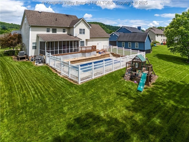 140 Waterside Cir, Winfield, WV 25213 - rear view of house with a sunroom, a playground, roof with shingles, and a residential view