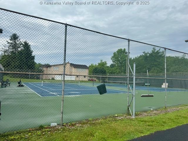 view of tennis court featuring fence