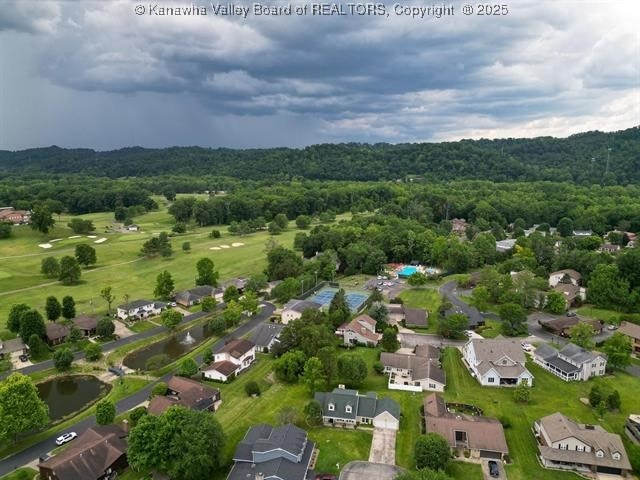 birds eye view of property featuring a residential view and a wooded view