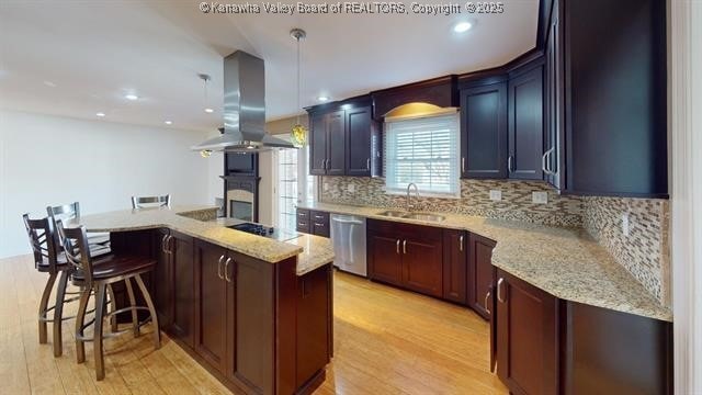 kitchen with a sink, light wood-type flooring, backsplash, dishwasher, and island exhaust hood