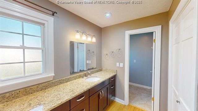 bathroom featuring vanity and baseboards